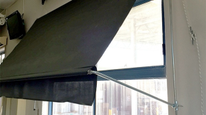 Black convertible awnings in a window