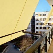 modern architecture building facade with convertible awnings balcony with convertible awning opened covered by sun shield convertibel awnings