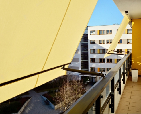 modern architecture building facade with convertible awnings balcony with convertible awning opened covered by sun shield convertibel awnings