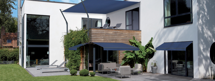 Dark blue folding arm awnings used in the outdoor space of a Sydney home