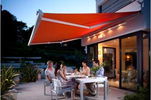 Folding arm awnings providing shade during outdoor dinner